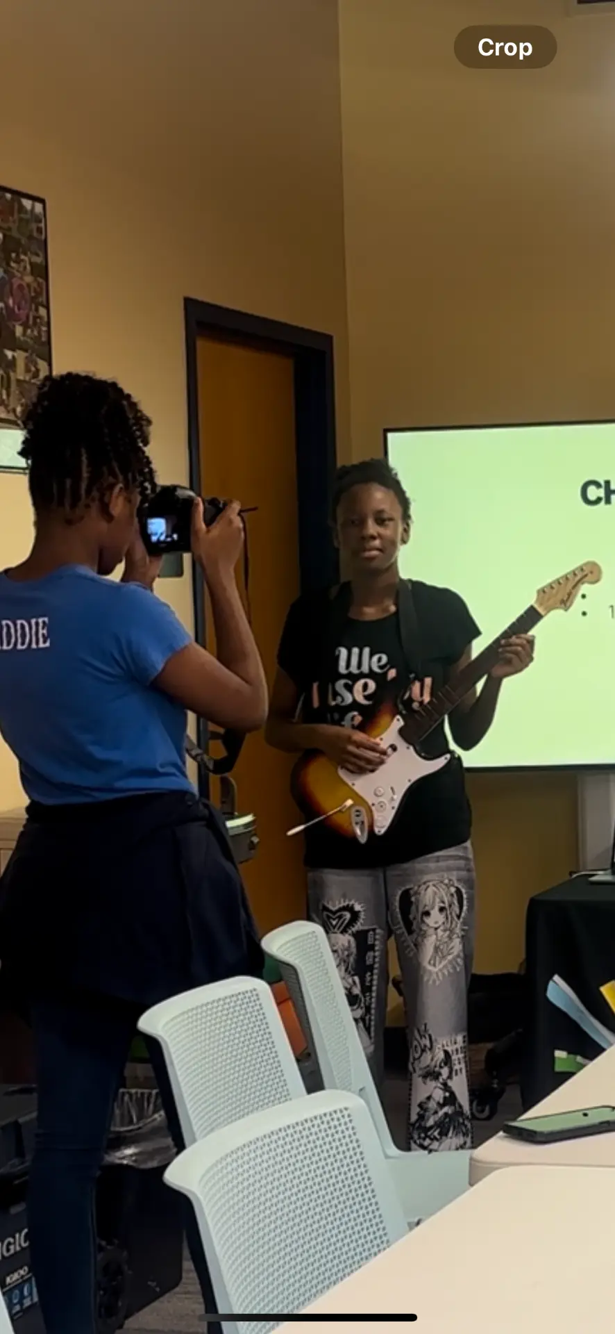 A participant photographing a friend with a guitar